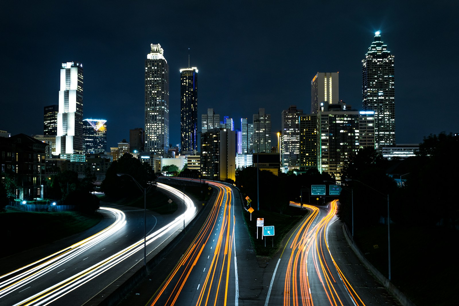 time lapse photo of passing cars during night time